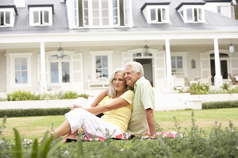 Extended-Family-Group-Sitting-Outside-House-On-Lawn1